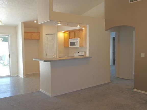Breakfast bar and kitchen opens to living and dining rooms