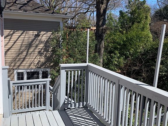 Apt 2 rear deck view to the trees and garden paths and greenery