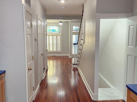 Main/1st floor hallway - to the right is stairs to the basement, to the left are doors for half bath, side closet and pantry