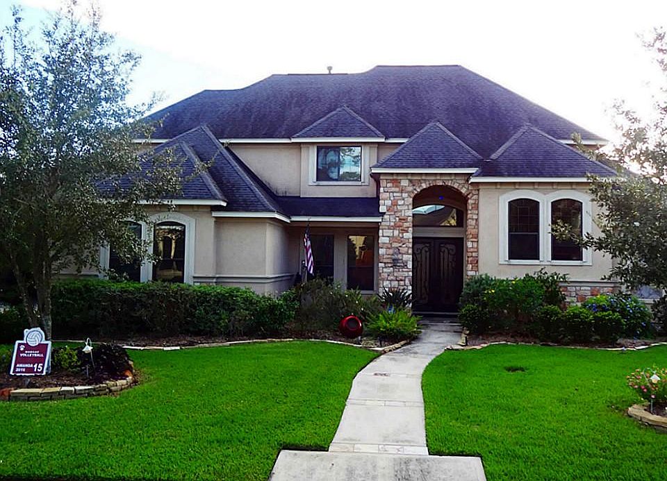 Beautiful curb appeal with mature, custom landscaping and pretty front porch.