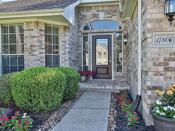Spacious welcoming entryway with colorful new landscaping leads up to your new lead glass and solid wood door.