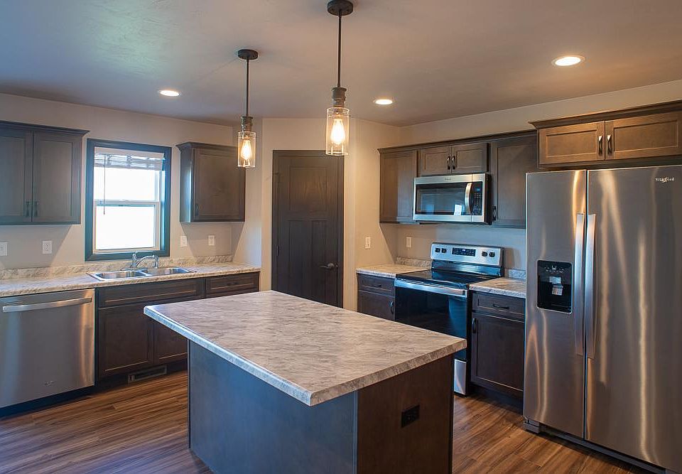 Open kitchen with modern lighting fixtures and appliances.
