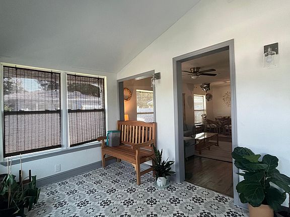 Walk into the bright and inviting sunroom with Old Florida character