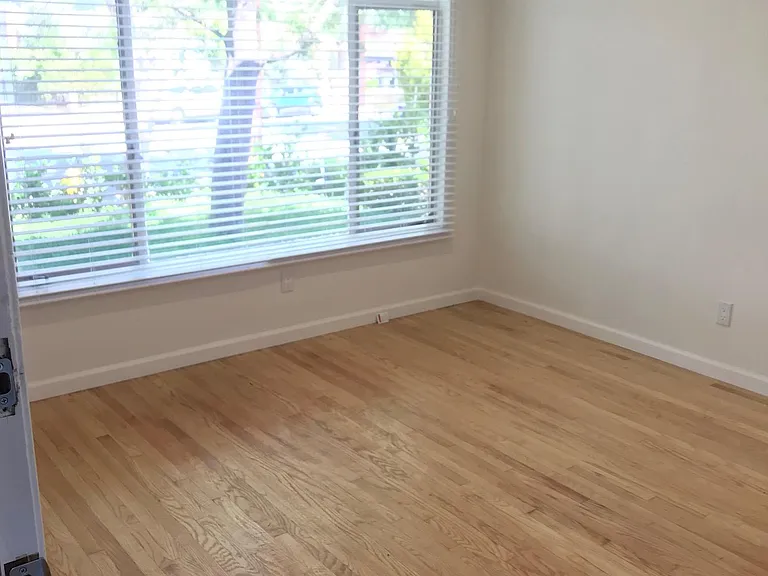 Living room has large window, good light and view of front yard.