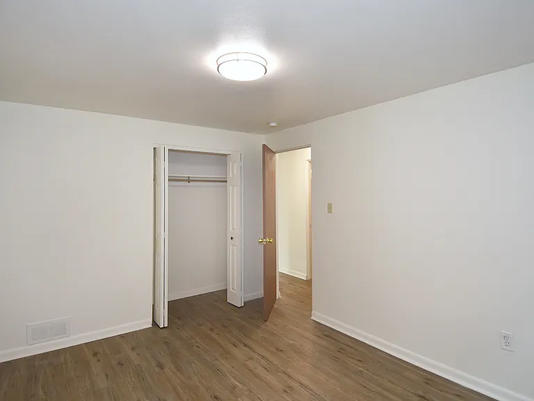 Freshly painted spacious bedroom #2 with all-new luxury vinyl plank flooring, new mini-blinds & LED lighting.