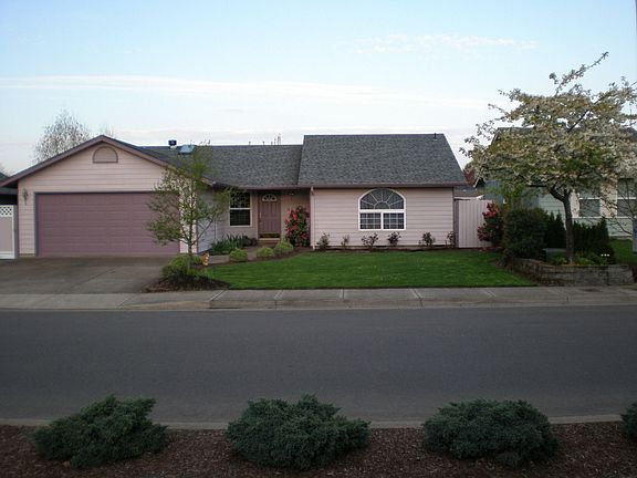 Raised beds, flowering trees, nice lawn.