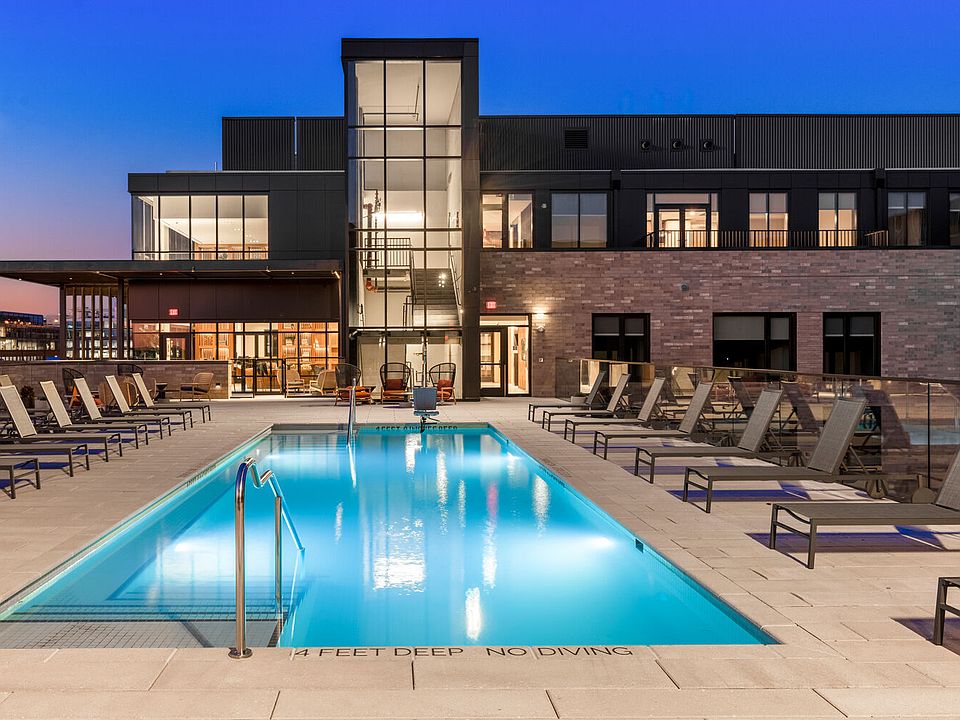 Rooftop pool deck with lap pool, lounge chairs and pavilions