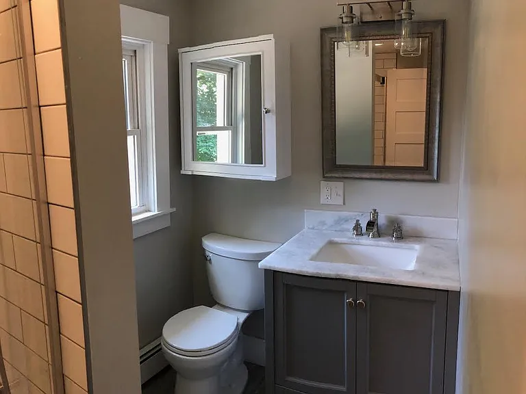 All new bath, tile floor, large medicine chest, vanity with storage drawer, and marble top.