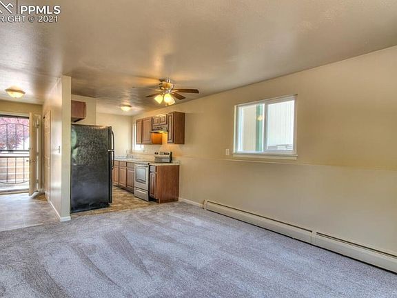 Living room looking into the entryway and kitchen