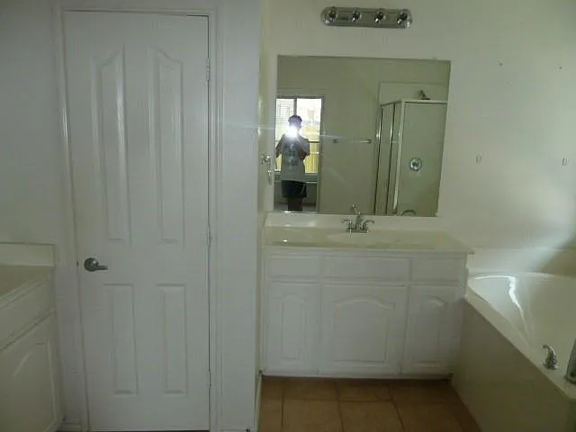 Master bath with tub and separate vanities