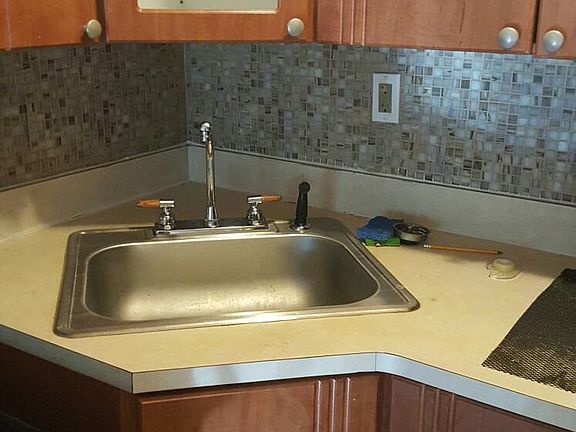Upgraded kitchen sink with splashboard tiles