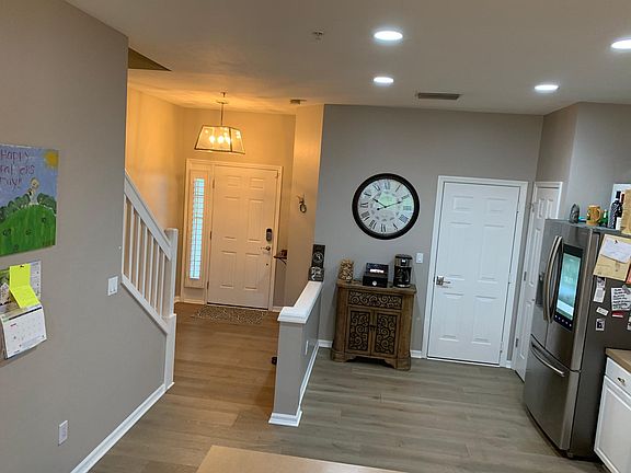 Here is that inviting entry way & the side of the kitchen you haven't seen yet! The door on the right goes to your attached garage! Which, btw has a custom epoxy floor!