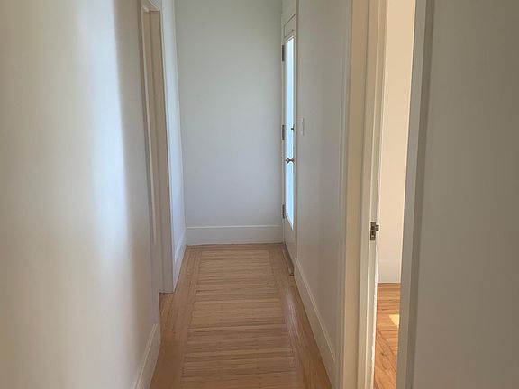 Hallway, looking to front door. Bathroom is on the left and bedroom is on the right.