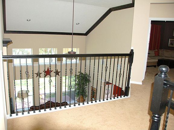 View from upstairs landing. Wall of windows in den w/ view of Large backyard