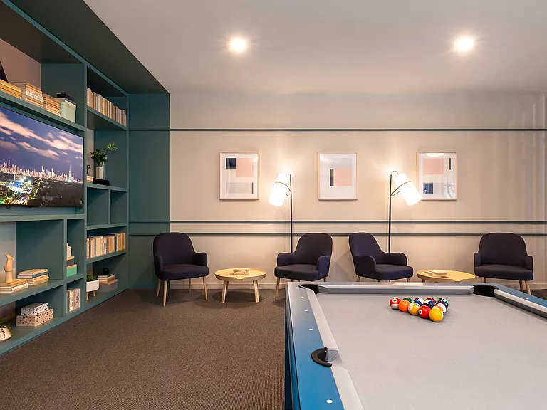 Kick back with friends or neighbors in Eleven33's cozy lounge complete with a pool table, elegant lighting, and relaxed seating designed for easy conversation.