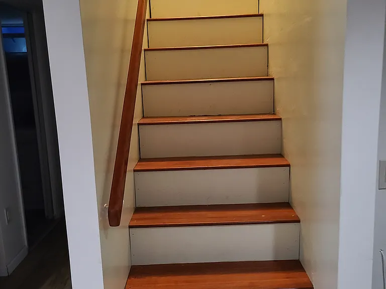 Stairs connecting the laundry room to the finished basement
