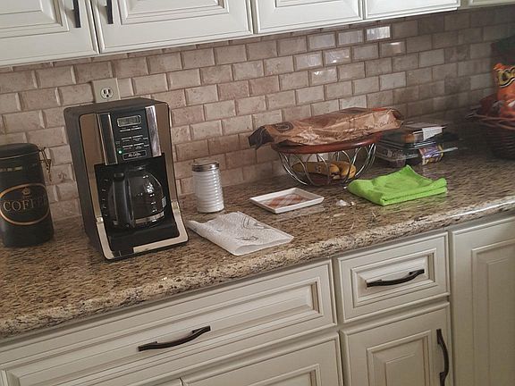 Kitchen with backsplash and soft close drawers and doors