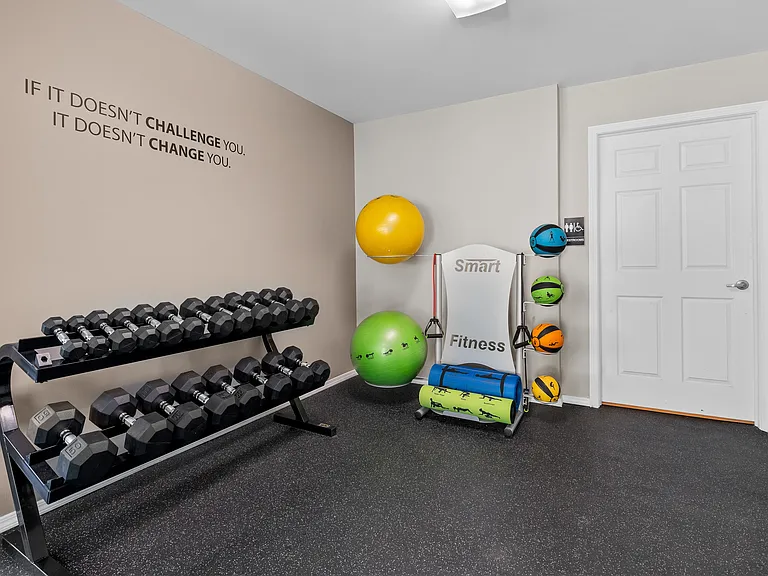 24-hour fitness center at cardio machines and weights at Woodland Villa Apartments in Westland, MI.