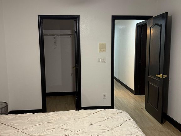Walk-in-closet and entrance of room.