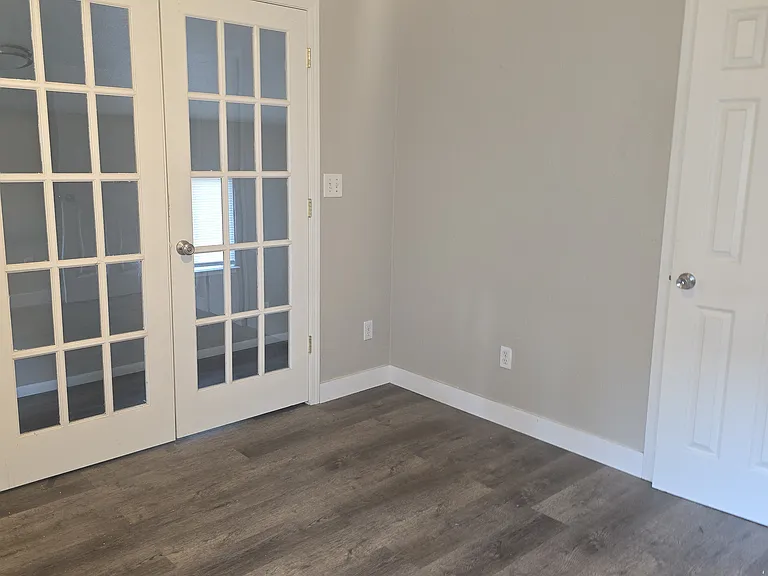 Bedroom with double doors to covered extra room ( Laundry hook ups )
