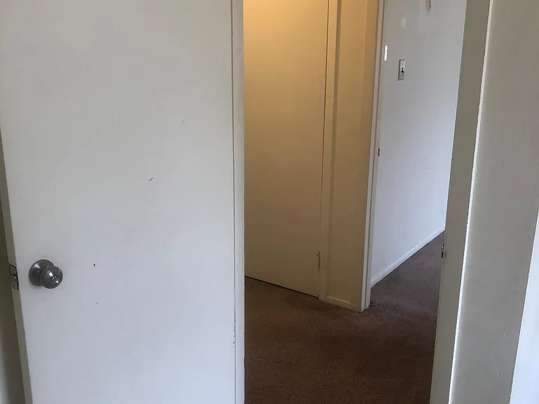 View from back bedroom into hallway. Front bedroom across hallway.