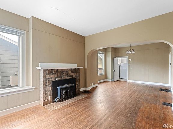 Main living space has tile fireplace and wood fireplace insert.  