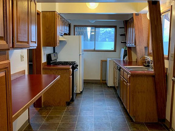 Entryway and kitchen. Side entry door is right of the sink.