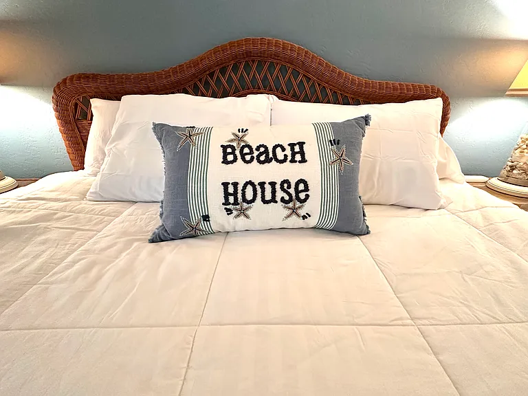 Welcome to the Beach House. __ It's all in the details! Our primary suite features a luxury king-size bed with a plush pillowtop mattress, complete with those perfect "beach house" vibes. It's the ultimate spot to drift off to sleep after a day of fun.