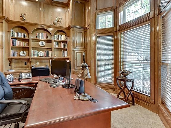 Private study with extensive woodwork and custom built ins