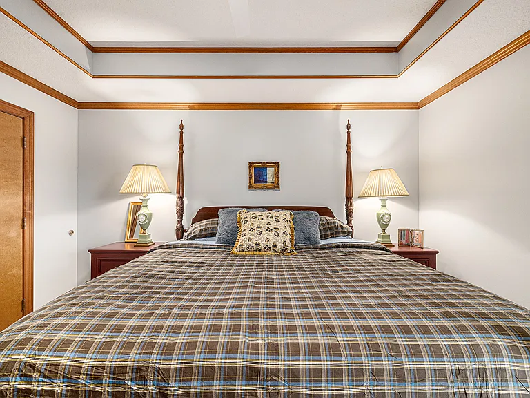 Spacious bedroom with a floor-covering rug, creating a warm and inviting retreat filled with natural light.