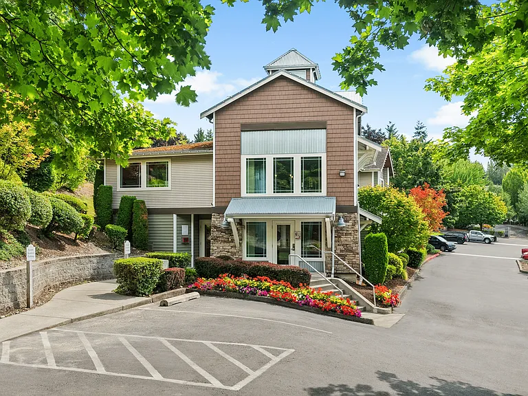 Welcome to our inviting clubhouse, surrounded by vibrant landscaping and plenty of resident parking.