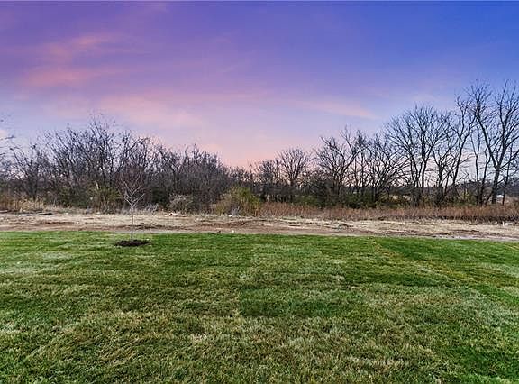Treed lined view lot back to a green space.