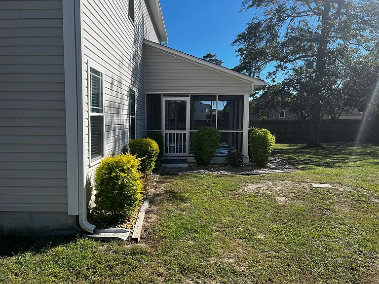 Covered side entry with convenient access to the backyard.