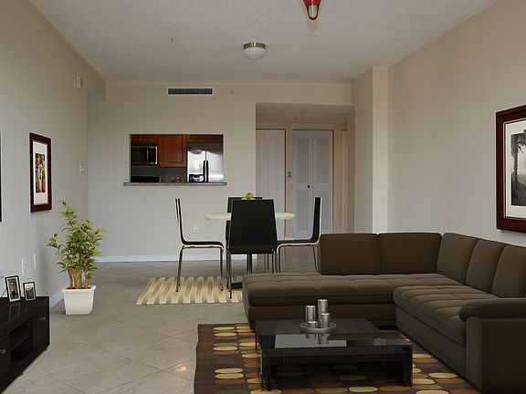 The living/dining area is bright and spacious with access to