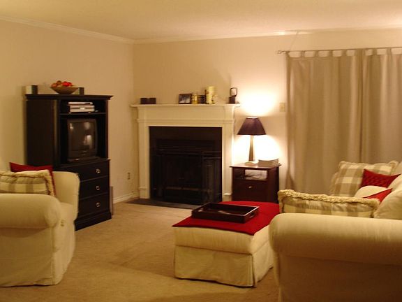 Living Room with Wood-Burning Fireplace and Double French Doors to Double Balconies