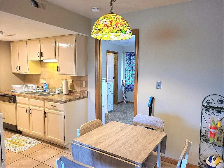 view of dining area and kitchen. Bedroom through door.