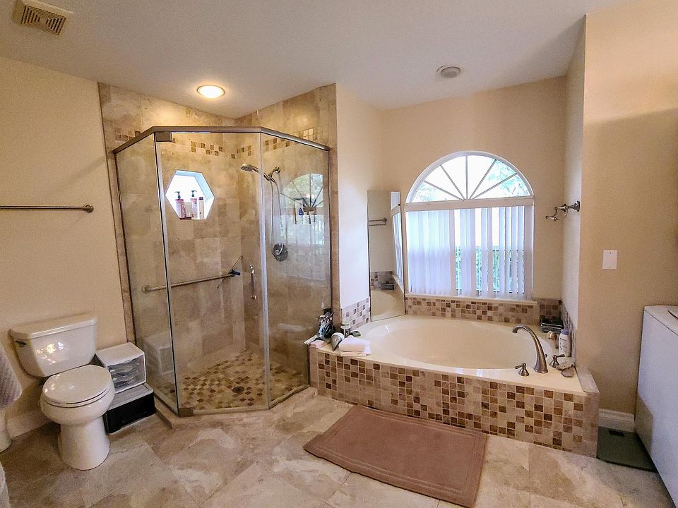 Spacious shower, towel bars/hooks and storage.