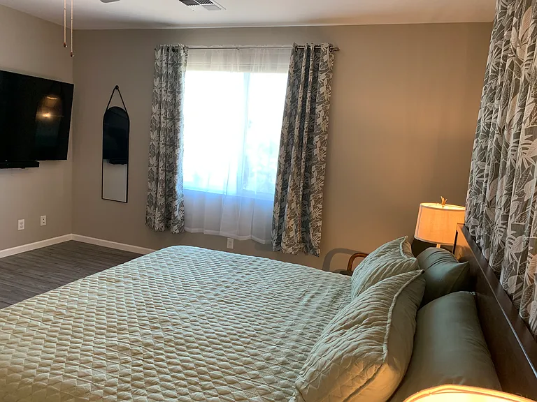 Large Flat Screen television that can be enjoyed while you relax in your king sized bed.