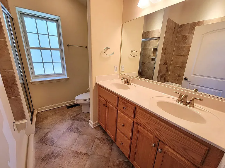 bathroom with his her sink