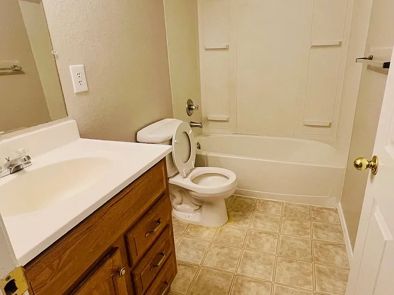 Basement full bathroom, actual photo. New LVP flooring being installed.