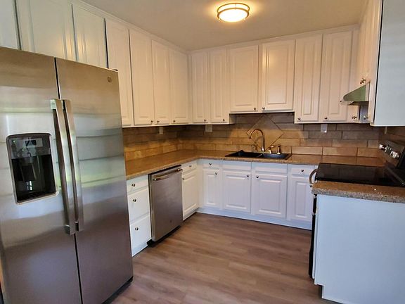Renovated Kitchen with ALL Stainless Steel Appliances (Range, Range Hood, Refrigerator, & Dishwasher) Granite Counter-tops, Lots of cabinet storage, and new luxury vinyl plank flooring.