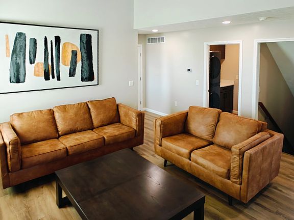 Main floor living area with gas fireplace, TV mount space and coat closet
