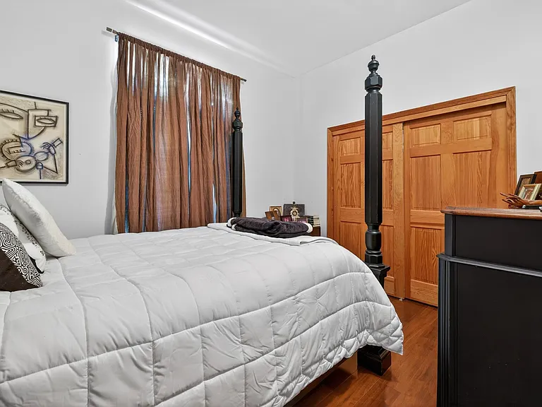 Bedroom with Queen bed and matching dresser.