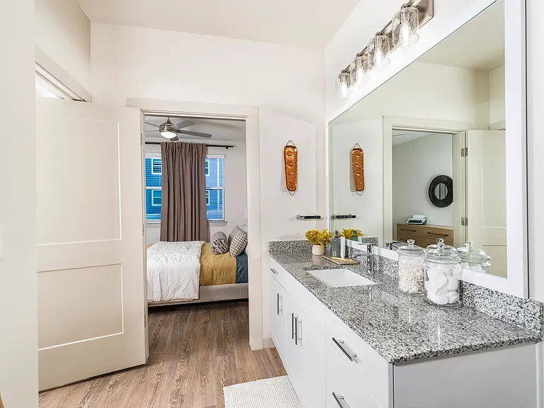 Bright and inviting bedroom retreat with direct access to your private bath at Beckett West Fork in Conroe.