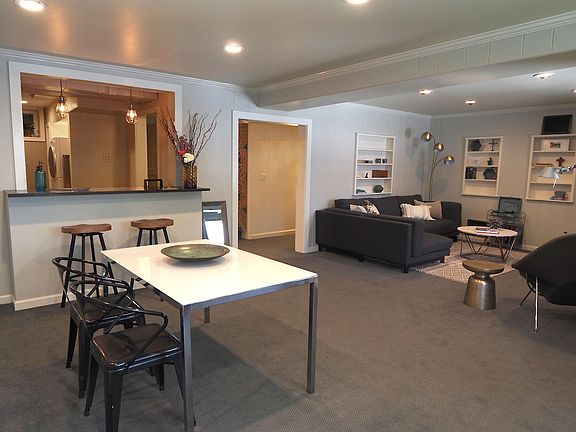Dining Room with bar stools/counter looking into kitchen.