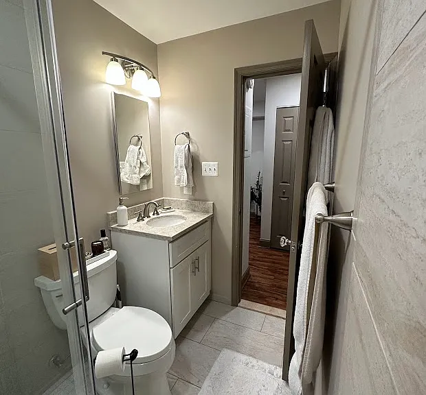 Custom cabinets, sink, and medicine cabinet mirror, matching the luxurious finishes of the kitchen