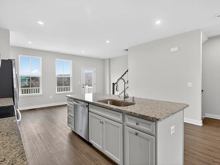 View of the granite countertops and large sink to the dining area; open concept living on 2nd floor