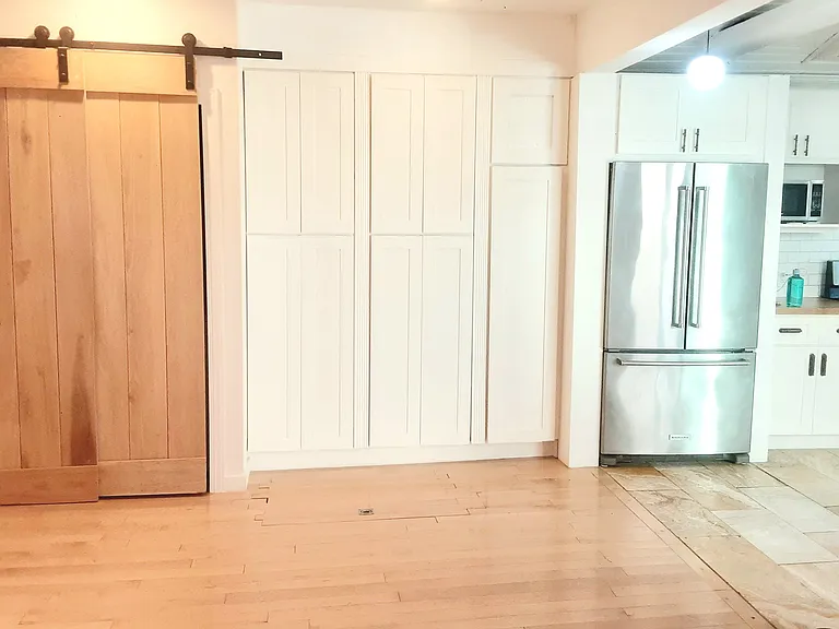 Open concept dining room. Washer and dryer are behind the sliding door.