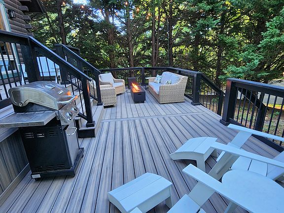 Trex deck install in 2023, couch, two rockers with waterproof covers, Adirondack chairs, gas grill, propane firetable.
