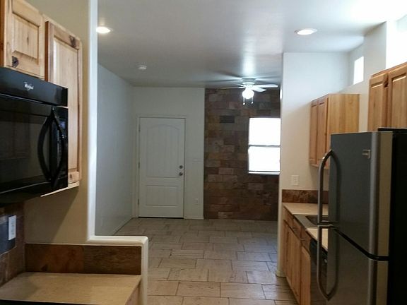 Two walls in the living room area covered with slate
